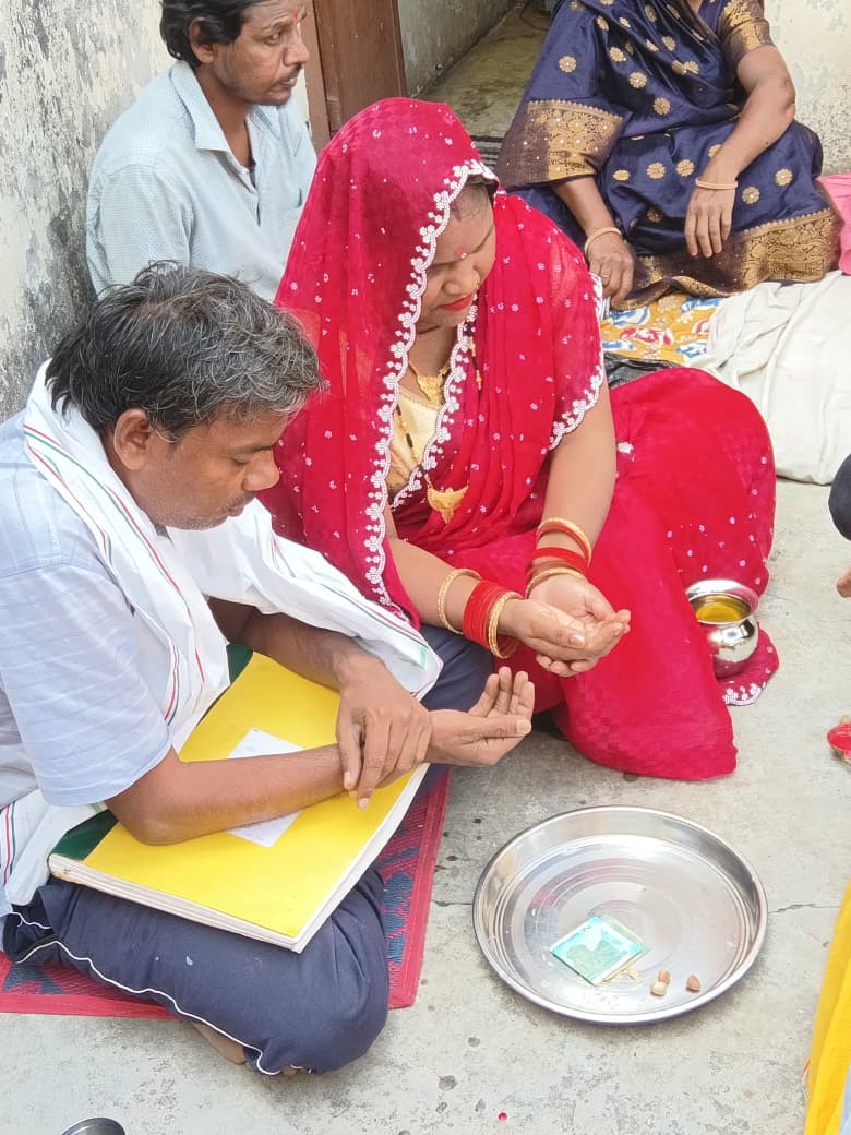 Mr.Sahu and Ms.Moni Rav sitting on the puja
